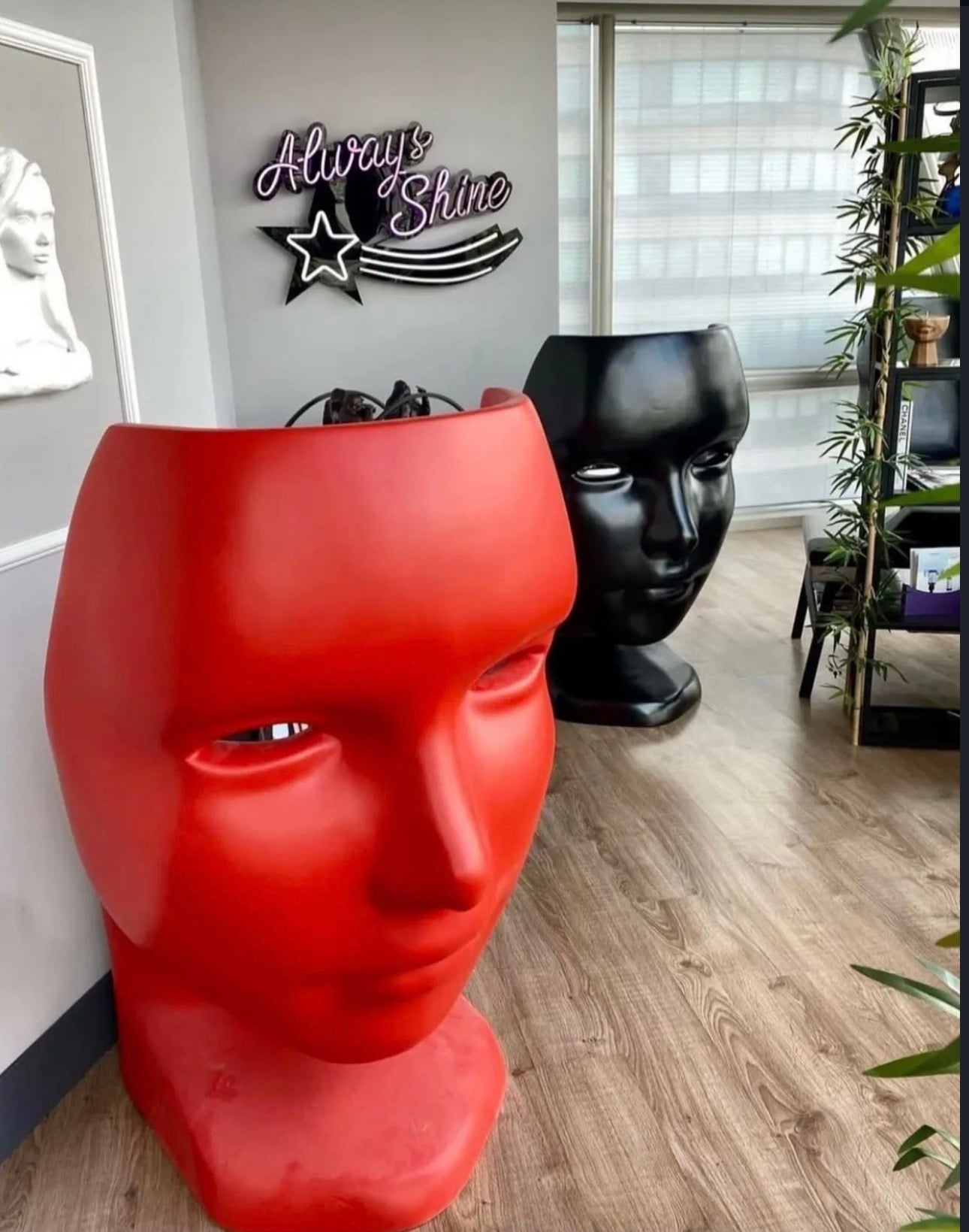 Chair sculptural human face seating in red and black finishes for luxury statement interiors.