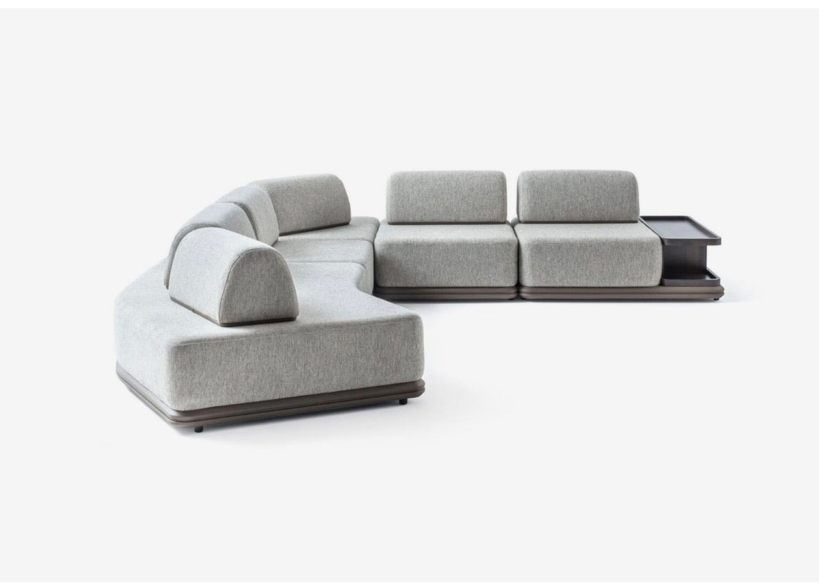 Afterglow modular sectional sofa collection with sculptural coffee tables and modern neutral lounge seating in a contemporary luxury interior.