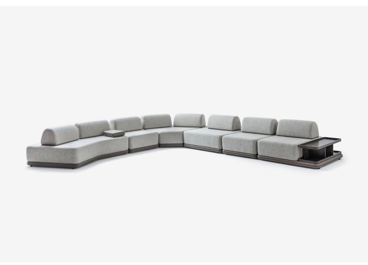 Afterglow modular sectional sofa collection with sculptural coffee tables and modern neutral lounge seating in a contemporary luxury interior.