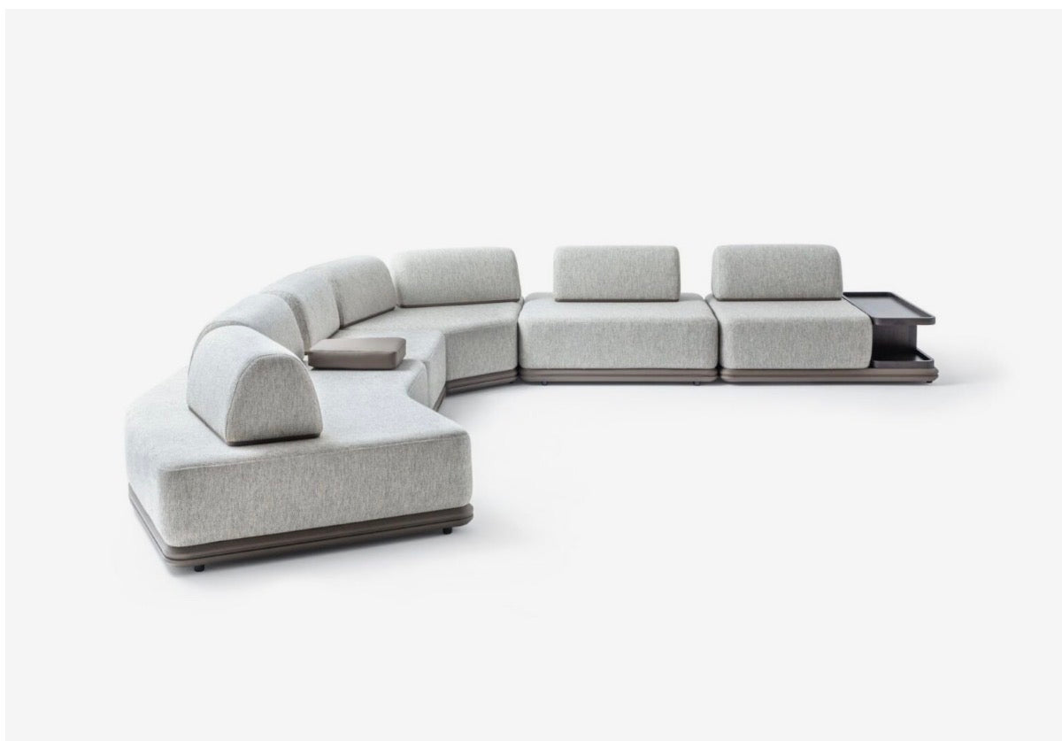 Afterglow modular sectional sofa collection with sculptural coffee tables and modern neutral lounge seating in a contemporary luxury interior.