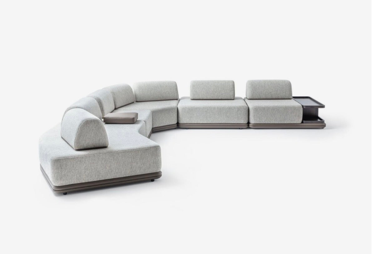 Afterglow modular sectional sofa collection with sculptural coffee tables and modern neutral lounge seating in a contemporary luxury interior.