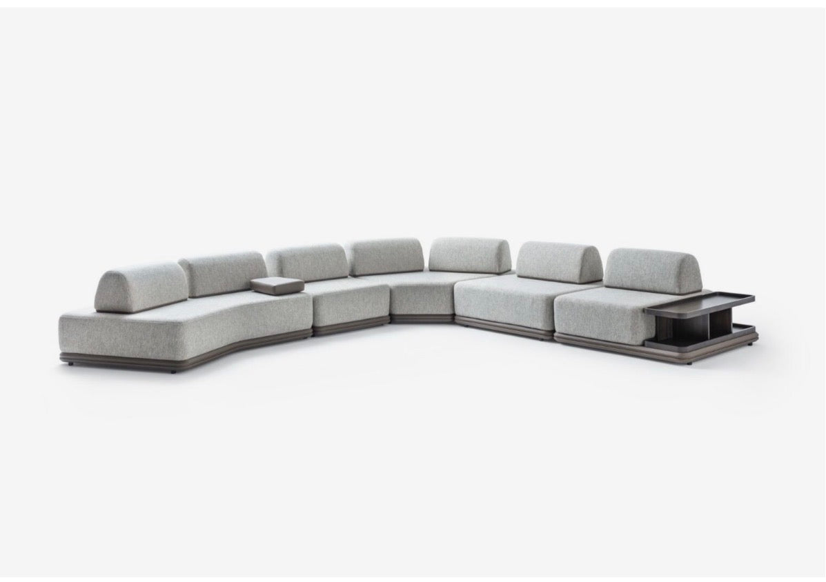 Afterglow modular sectional sofa collection with sculptural coffee tables and modern neutral lounge seating in a contemporary luxury interior.