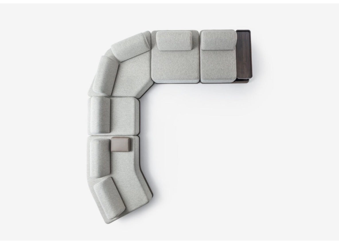 Afterglow modular sectional sofa collection with sculptural coffee tables and modern neutral lounge seating in a contemporary luxury interior.