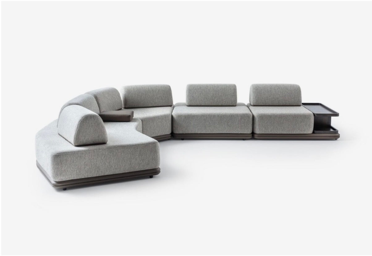 Afterglow modular sectional sofa collection with sculptural coffee tables and modern neutral lounge seating in a contemporary luxury interior.