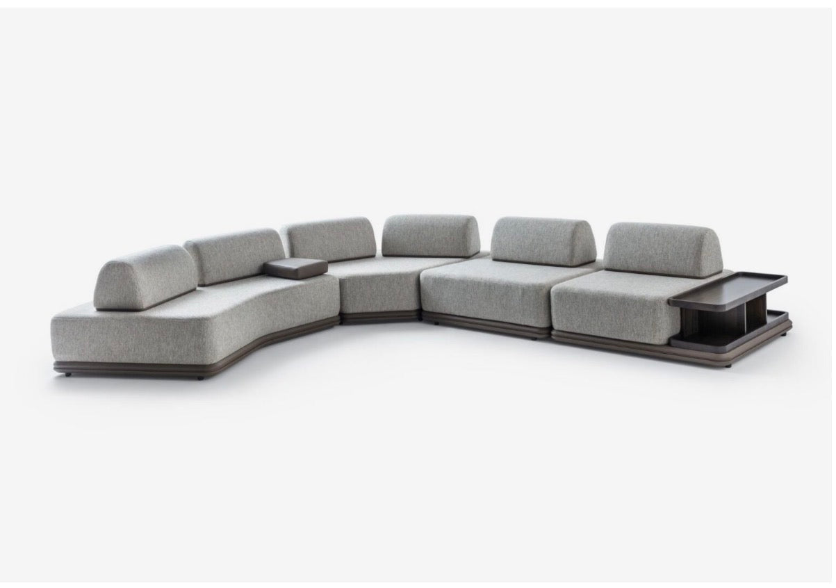 Afterglow modular sectional sofa collection with sculptural coffee tables and modern neutral lounge seating in a contemporary luxury interior.