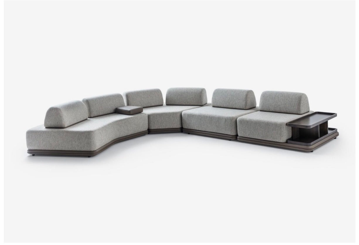 Afterglow modular sectional sofa collection with sculptural coffee tables and modern neutral lounge seating in a contemporary luxury interior.
