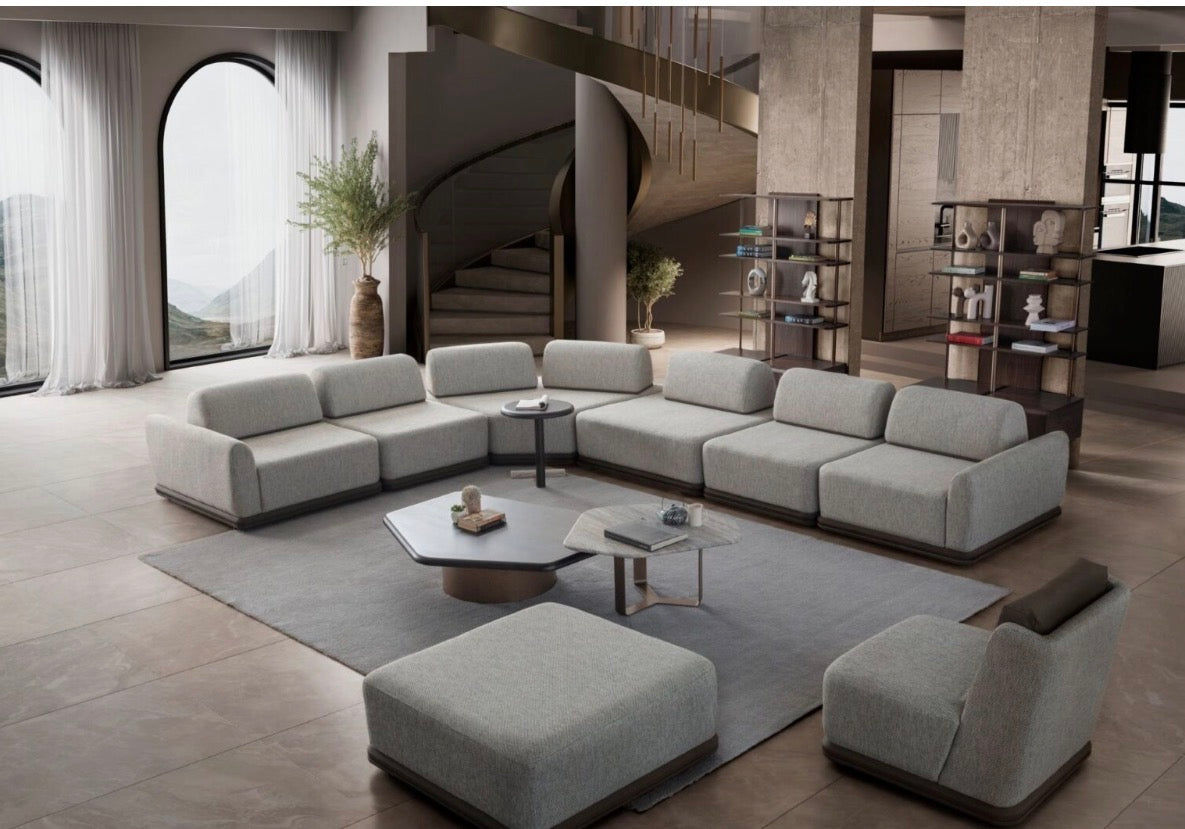 Afterglow modular sectional sofa collection with sculptural coffee tables and modern neutral lounge seating in a contemporary luxury interior.