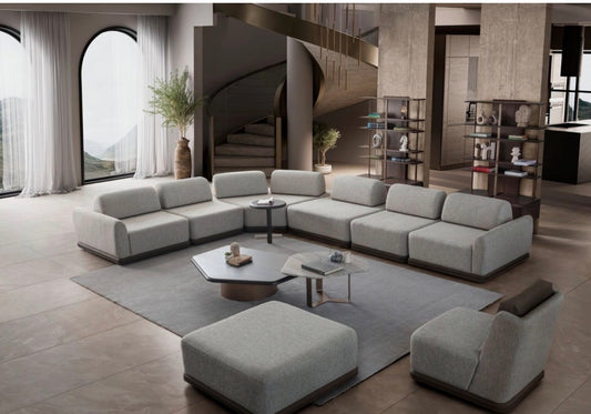 Afterglow modular sectional sofa collection with sculptural coffee tables and modern neutral lounge seating in a contemporary luxury interior.
