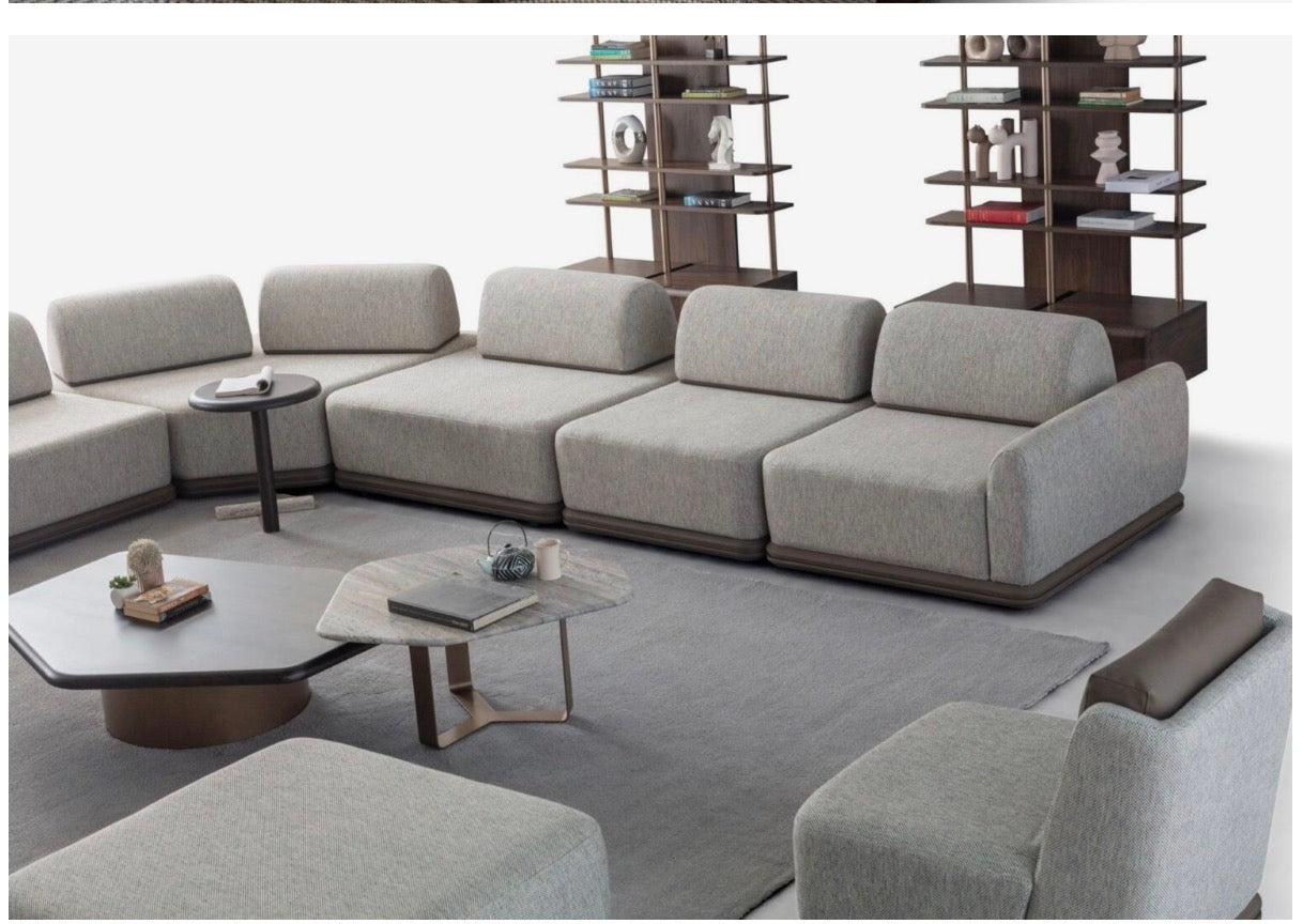 Afterglow modular sectional sofa collection with sculptural coffee tables and modern neutral lounge seating in a contemporary luxury interior.