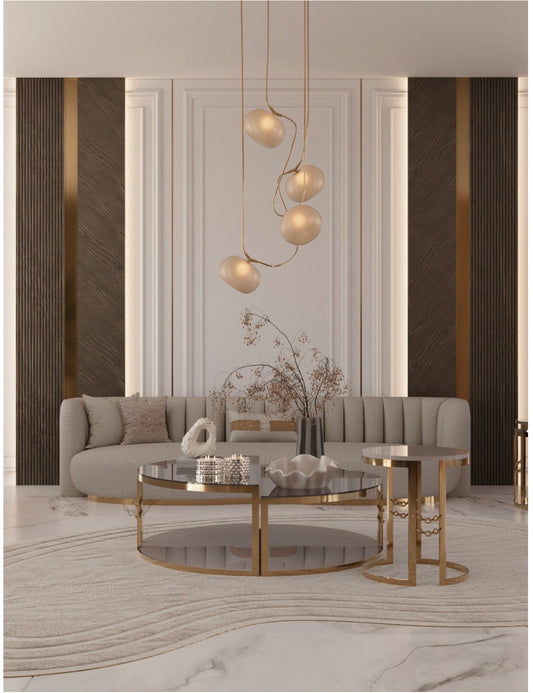 Modern luxury living room and dining set with curved sofas, sculptural chairs, and gold accent tables in neutral interior.