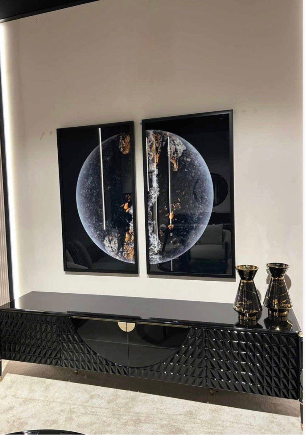Portrait luxury furniture collection featuring glossy black dining table, sculptural cabinet, and modern curved seating in a contemporary interior.