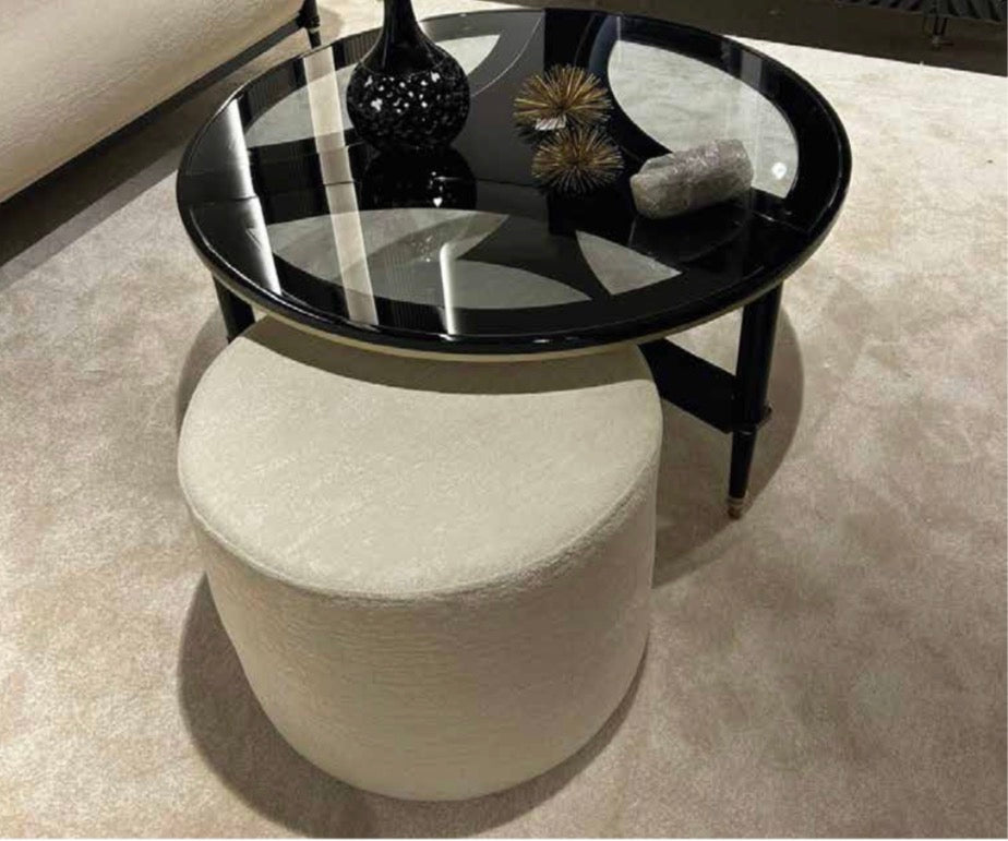 Portrait luxury furniture collection featuring glossy black dining table, sculptural cabinet, and modern curved seating in a contemporary interior.