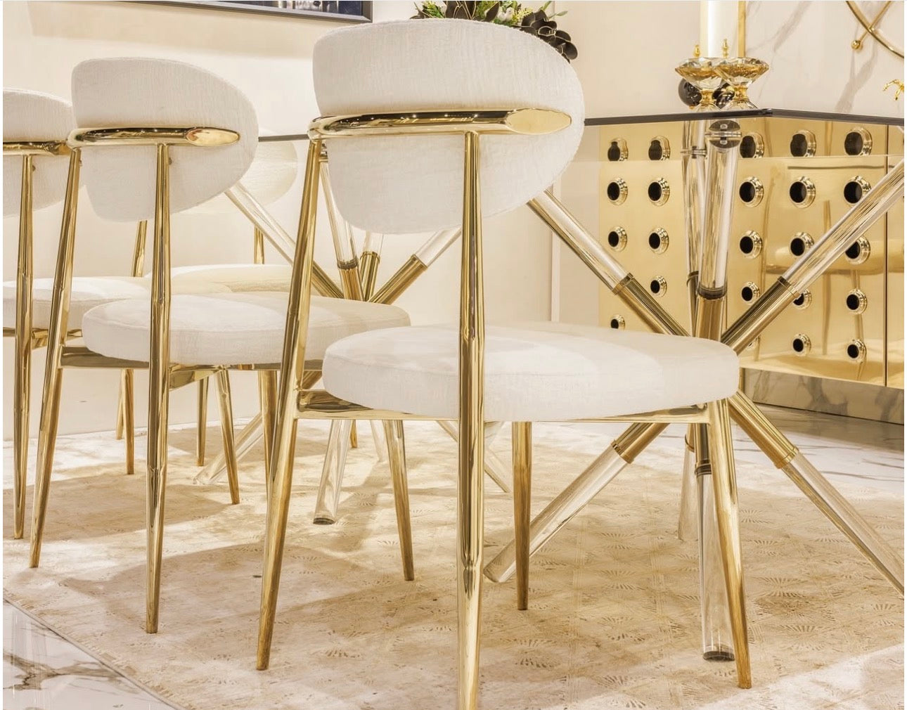 Ivory luxury furniture collection with gold sideboard, marble walls, white seating, and modern high-end living and dining design.