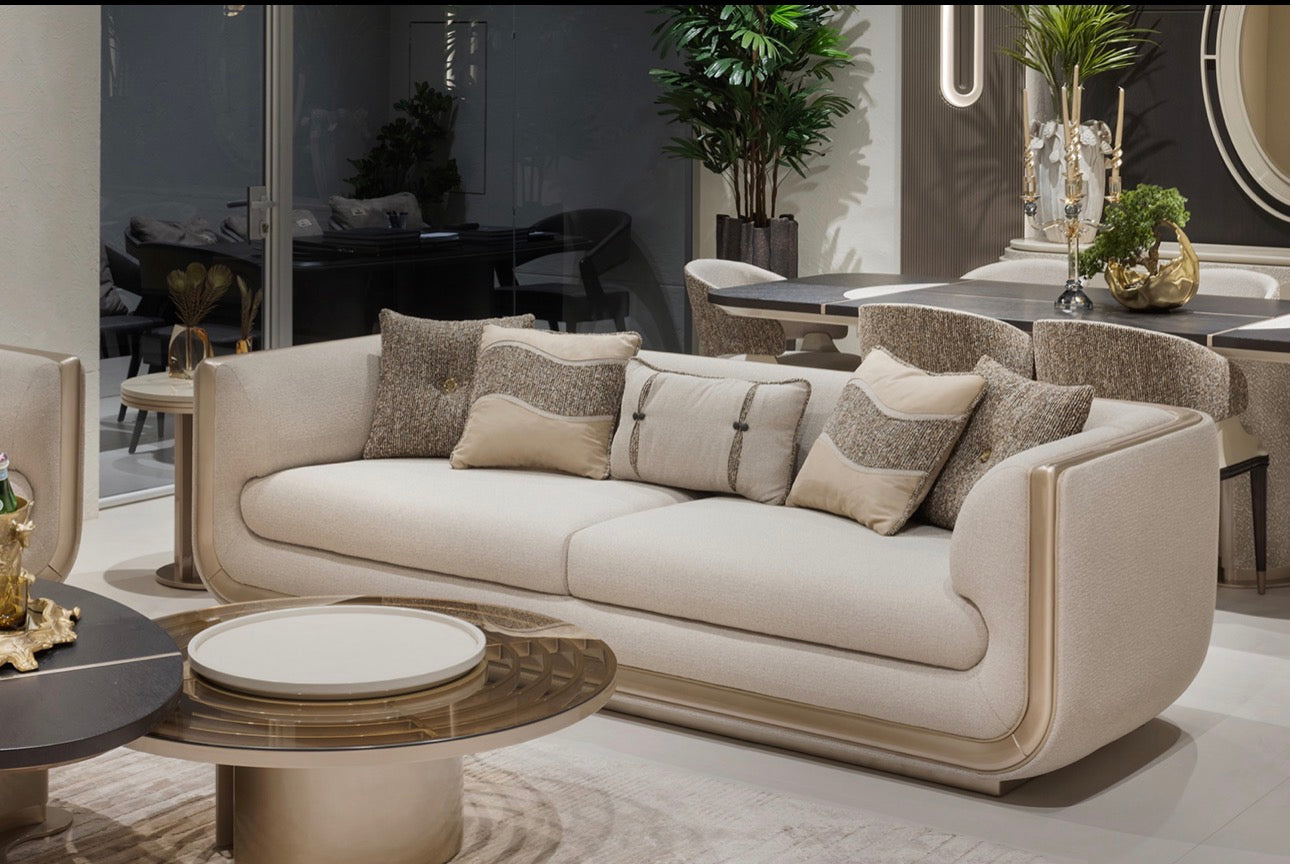 Prelude luxury furniture collection featuring modern sofa seating, elegant dining table with upholstered chairs, and contemporary neutral interior design.