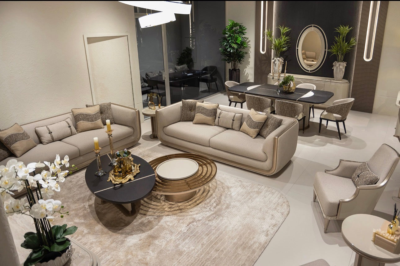Prelude luxury furniture collection featuring modern sofa seating, elegant dining table with upholstered chairs, and contemporary neutral interior design.