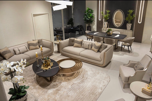 Prelude luxury furniture collection featuring modern sofa seating, elegant dining table with upholstered chairs, and contemporary neutral interior design.