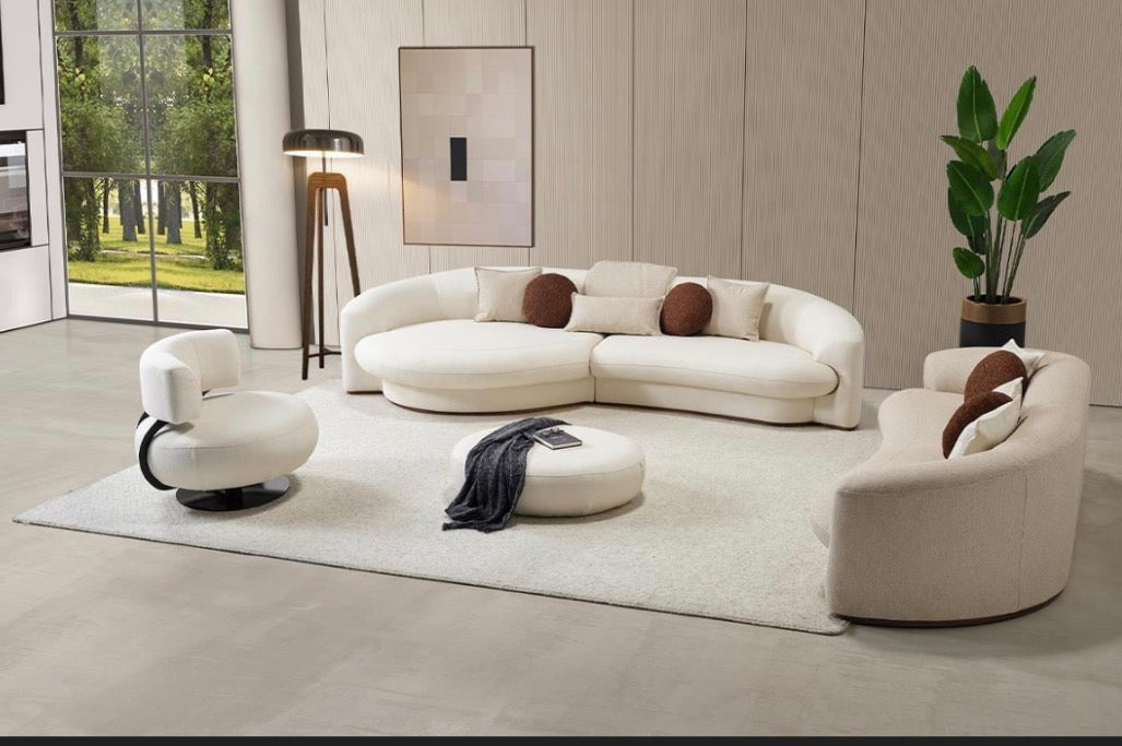 Hush curved sofa furniture collection featuring soft neutral lounge seating and sculptural modern living room design.