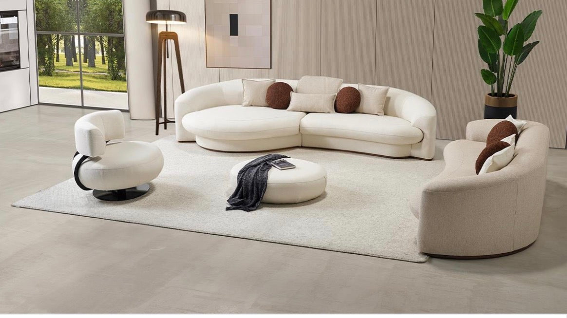 Hush curved sofa furniture collection featuring soft neutral lounge seating and sculptural modern living room design.