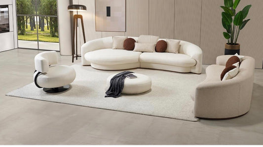 Hush curved sofa furniture collection featuring soft neutral lounge seating and sculptural modern living room design.
