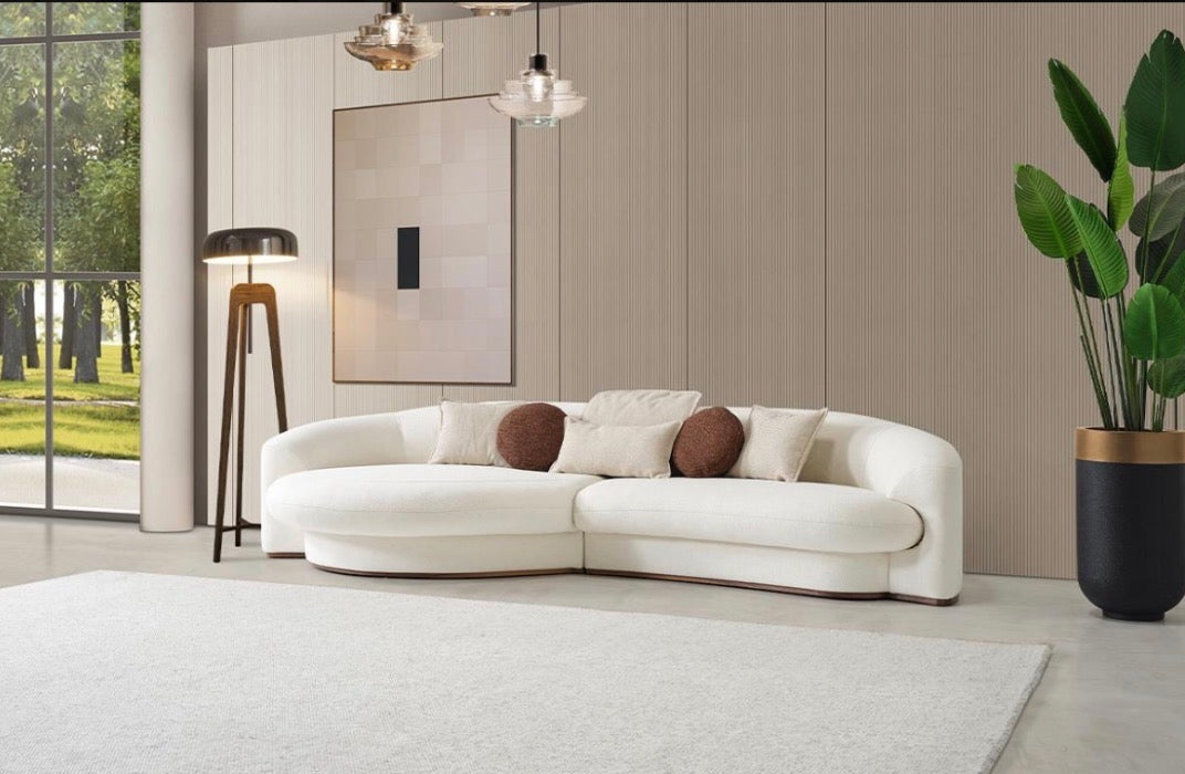 Hush curved sofa furniture collection featuring soft neutral lounge seating and sculptural modern living room design.