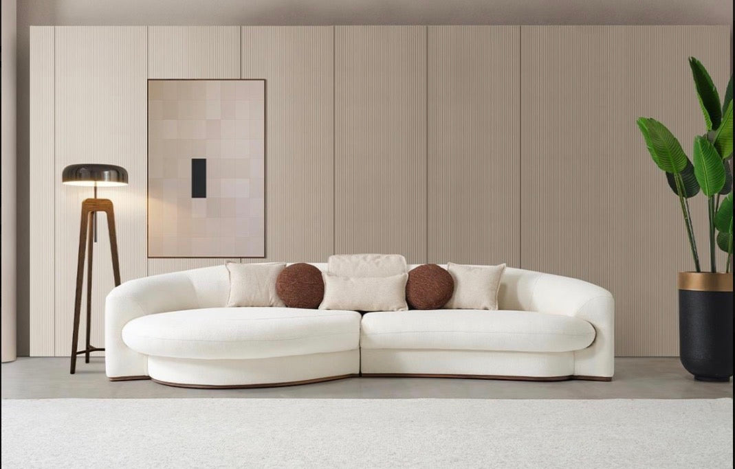 Hush curved sofa furniture collection featuring soft neutral lounge seating and sculptural modern living room design.