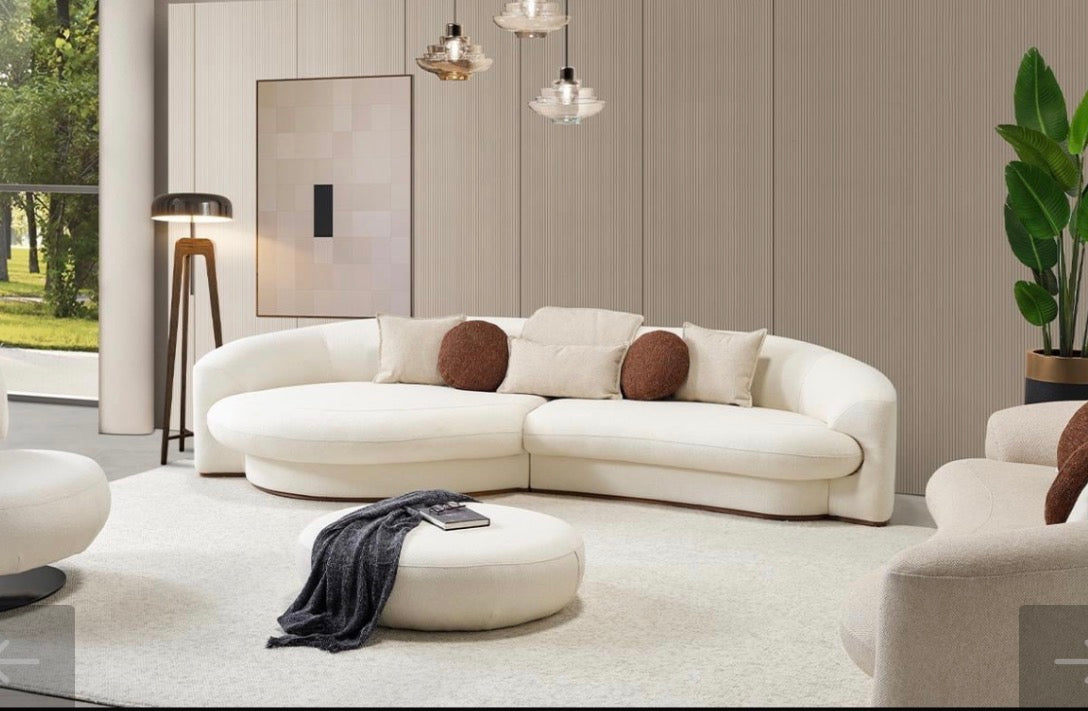 Hush curved sofa furniture collection featuring soft neutral lounge seating and sculptural modern living room design.