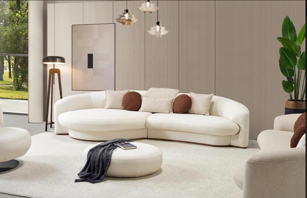 Hush curved sofa furniture collection featuring soft neutral lounge seating and sculptural modern living room design.