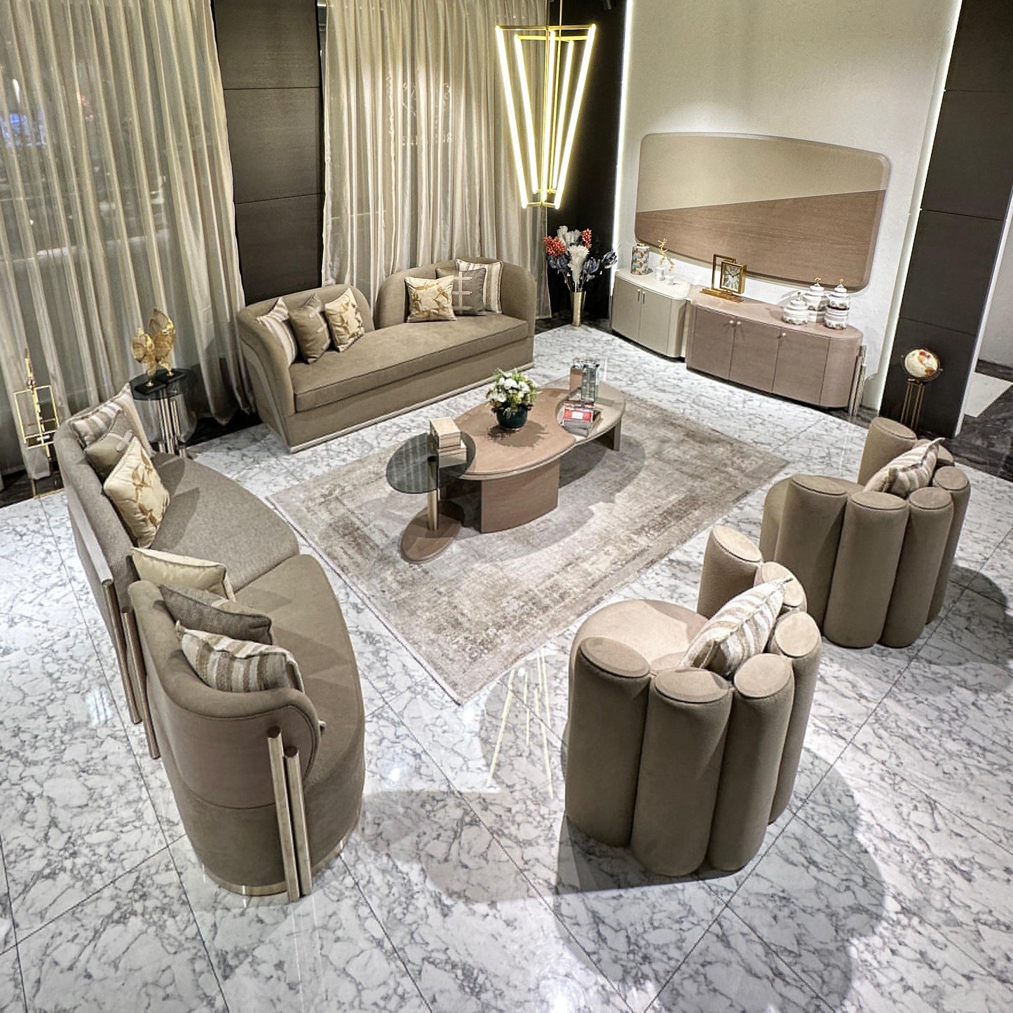 Sonata luxury furniture collection featuring curved modern sofas, sculptural accent chairs, and contemporary dining table in warm neutral tones.