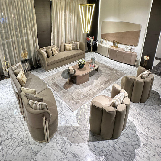 Sonata luxury furniture collection featuring curved modern sofas, sculptural accent chairs, and contemporary dining table in warm neutral tones.
