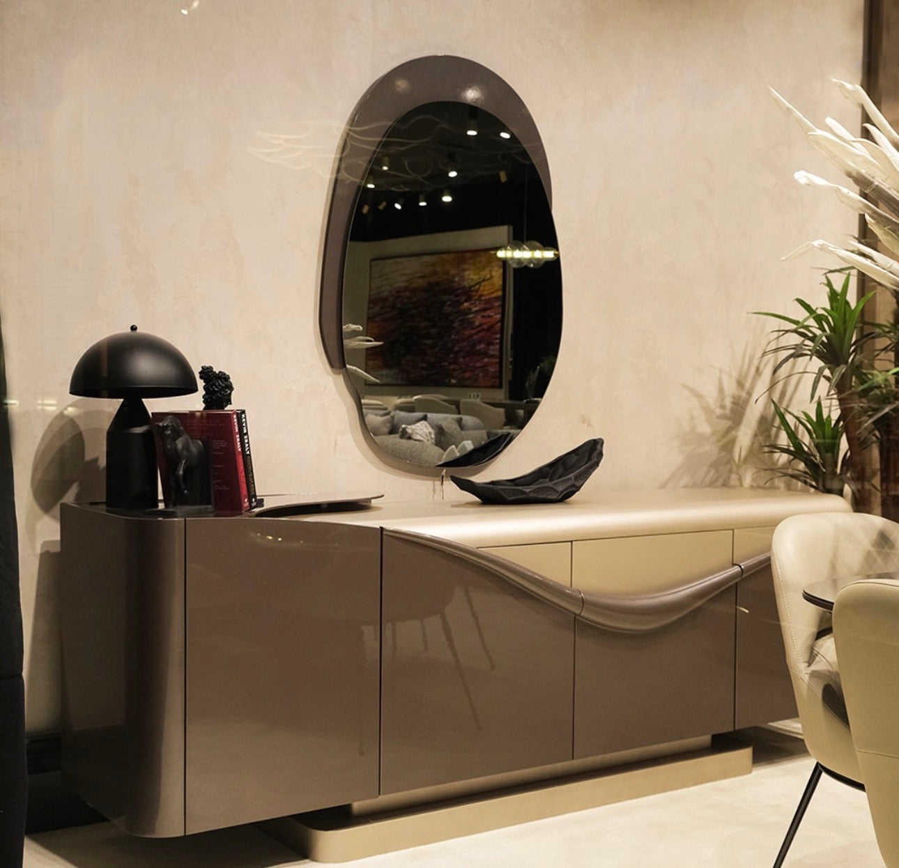 Regal luxury furniture collection featuring curved sofa seating, modern dining table with upholstered chairs, and contemporary living room design.