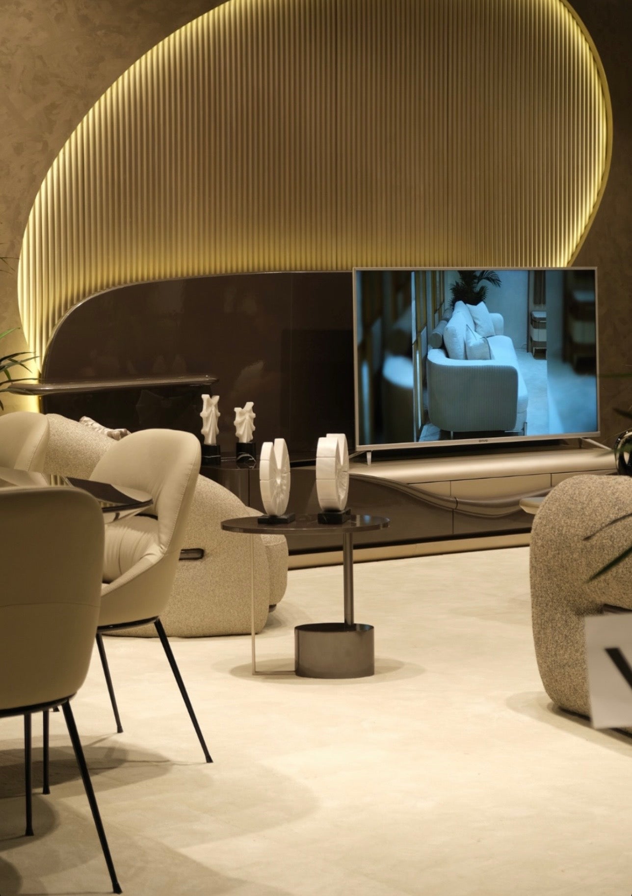 Regal luxury furniture collection featuring curved sofa seating, modern dining table with upholstered chairs, and contemporary living room design.