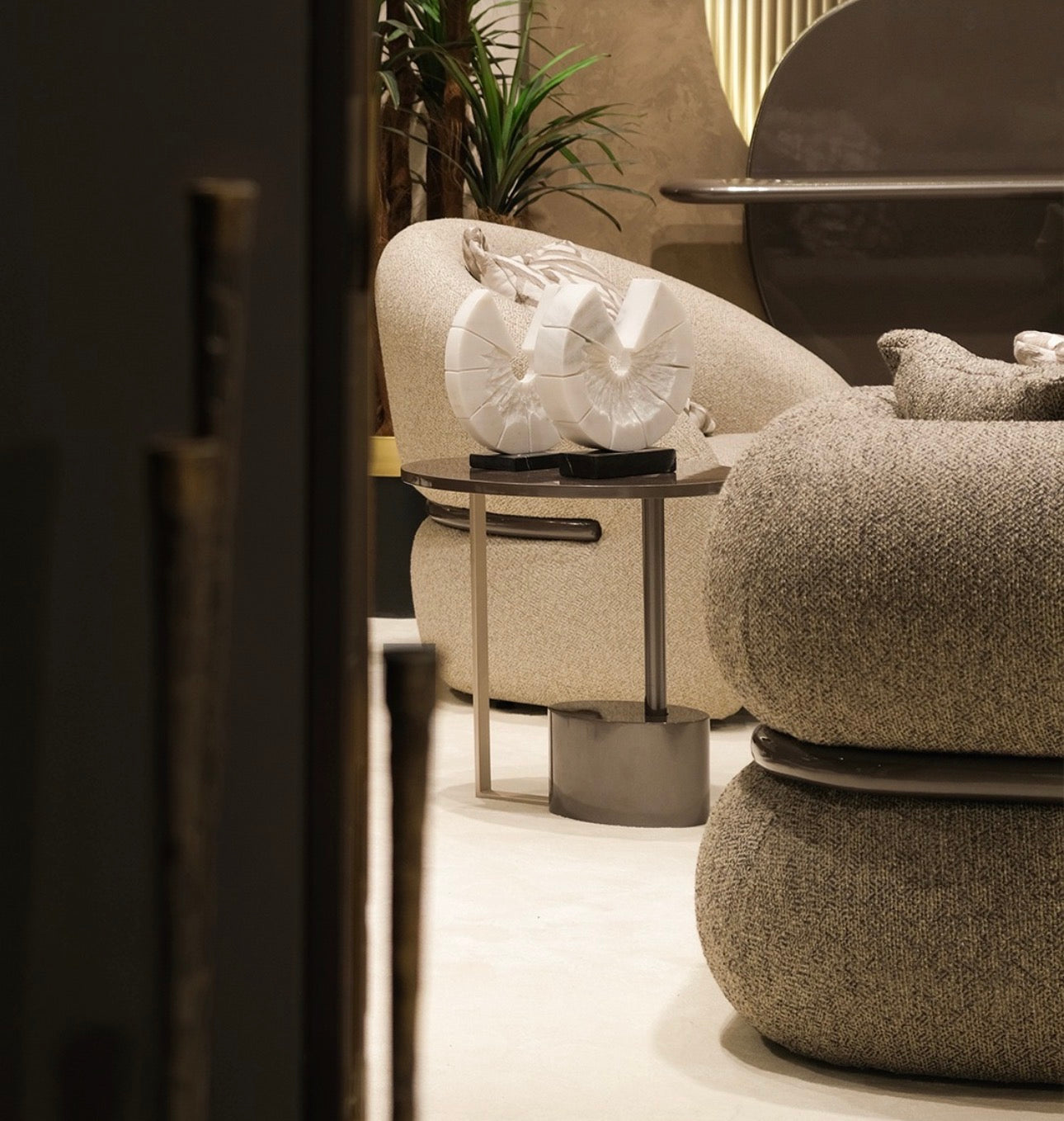 Regal luxury furniture collection featuring curved sofa seating, modern dining table with upholstered chairs, and contemporary living room design.