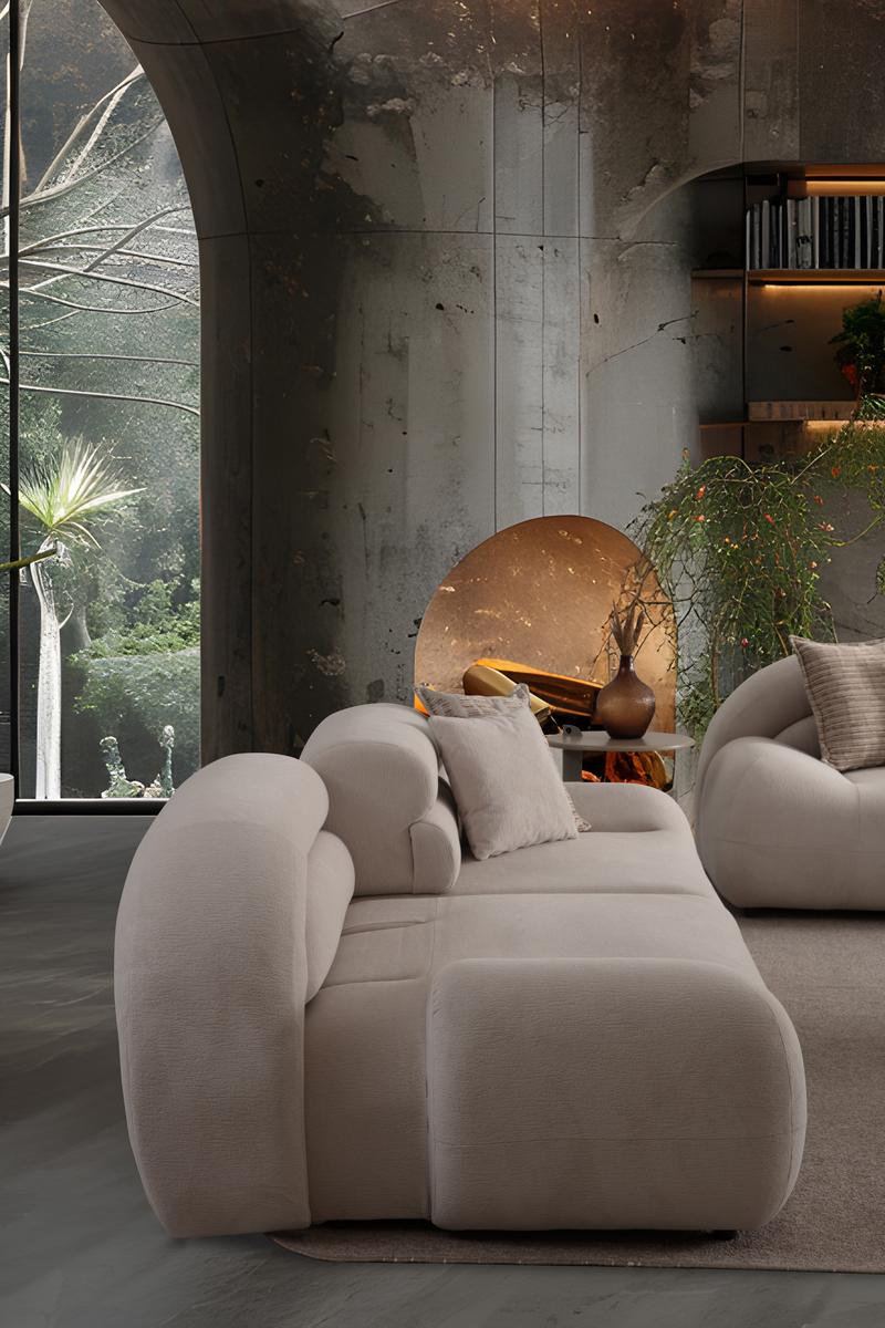 Valour modern luxury living room furniture collection featuring sculptural curved sofas, neutral upholstery, and minimalist contemporary design.