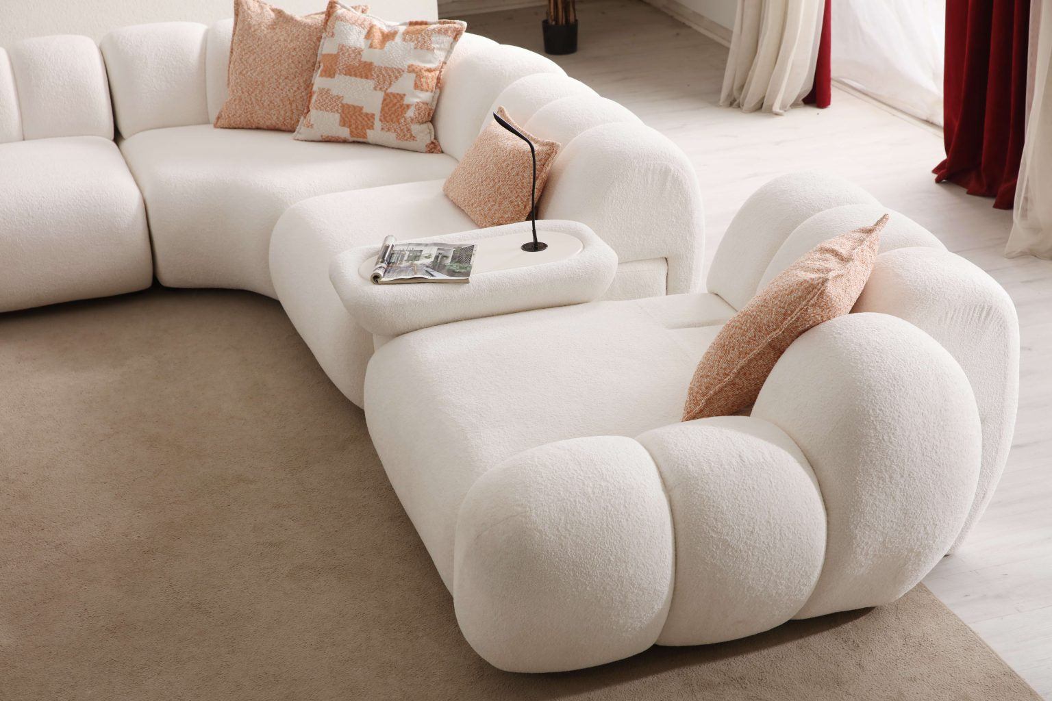 Lunar sculptural living room collection featuring curved modular sofa, rounded lounge chair, and modern minimalist interior design.