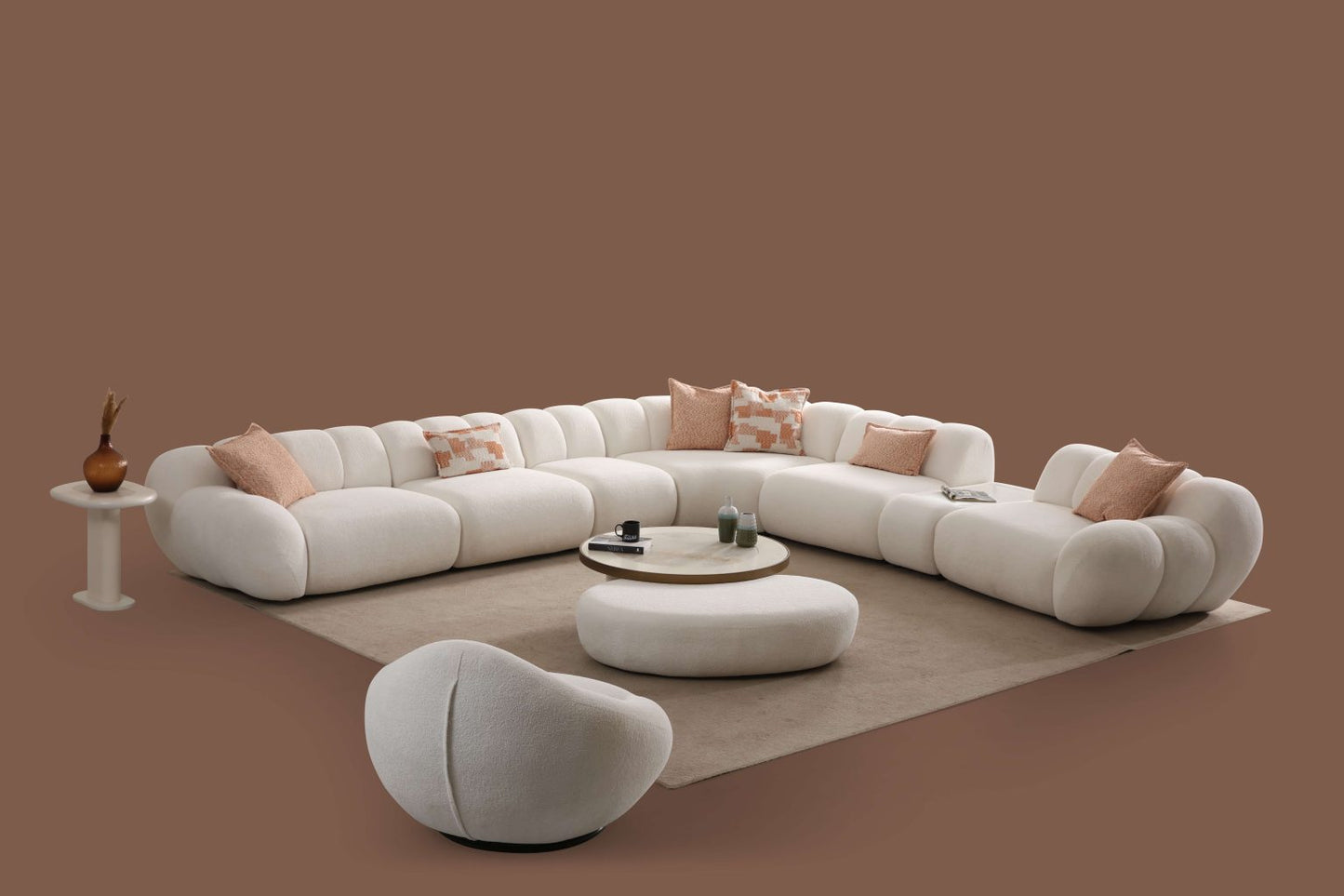 Lunar sculptural living room collection featuring curved modular sofa, rounded lounge chair, and modern minimalist interior design.