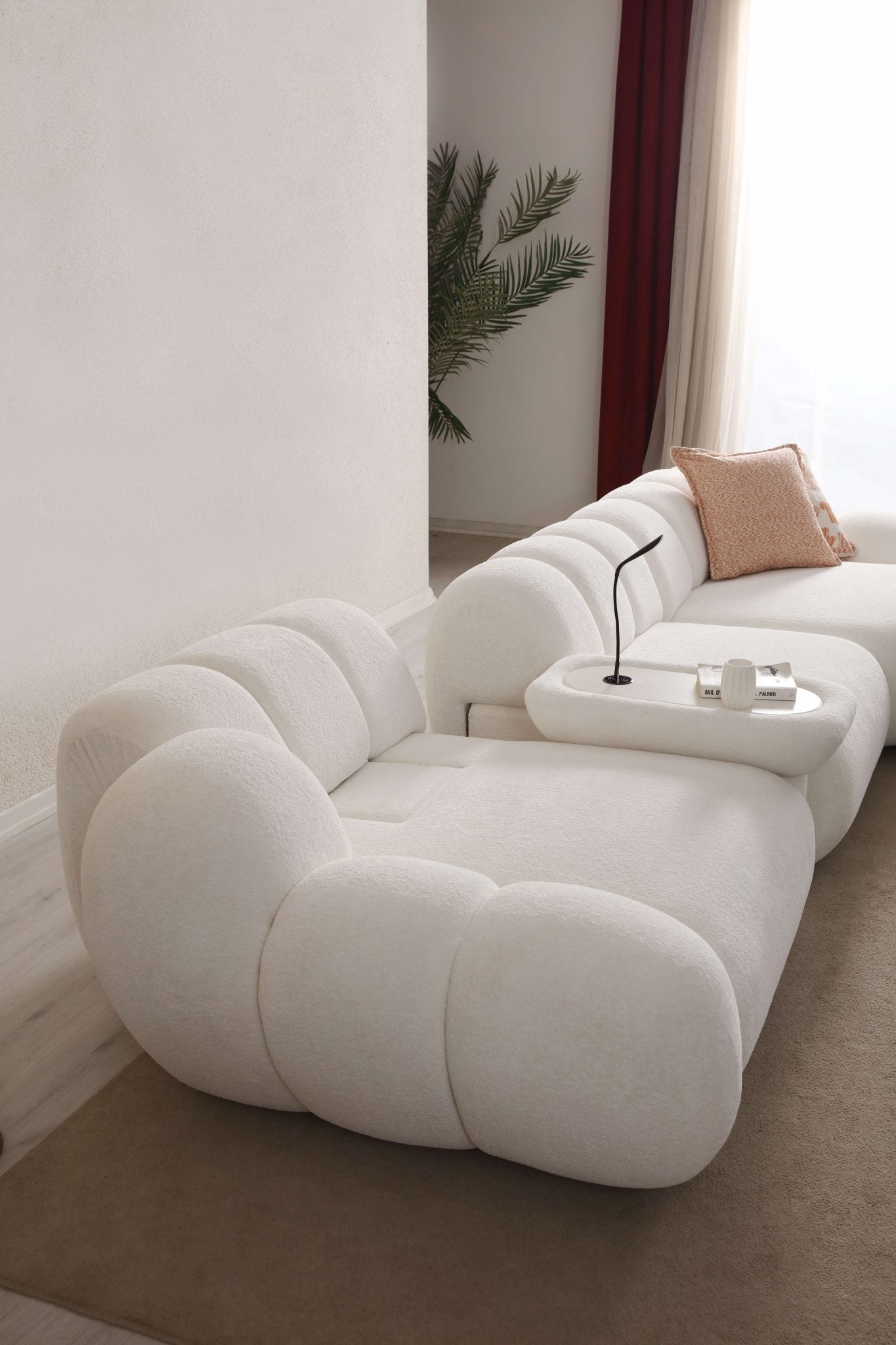 Lunar sculptural living room collection featuring curved modular sofa, rounded lounge chair, and modern minimalist interior design.