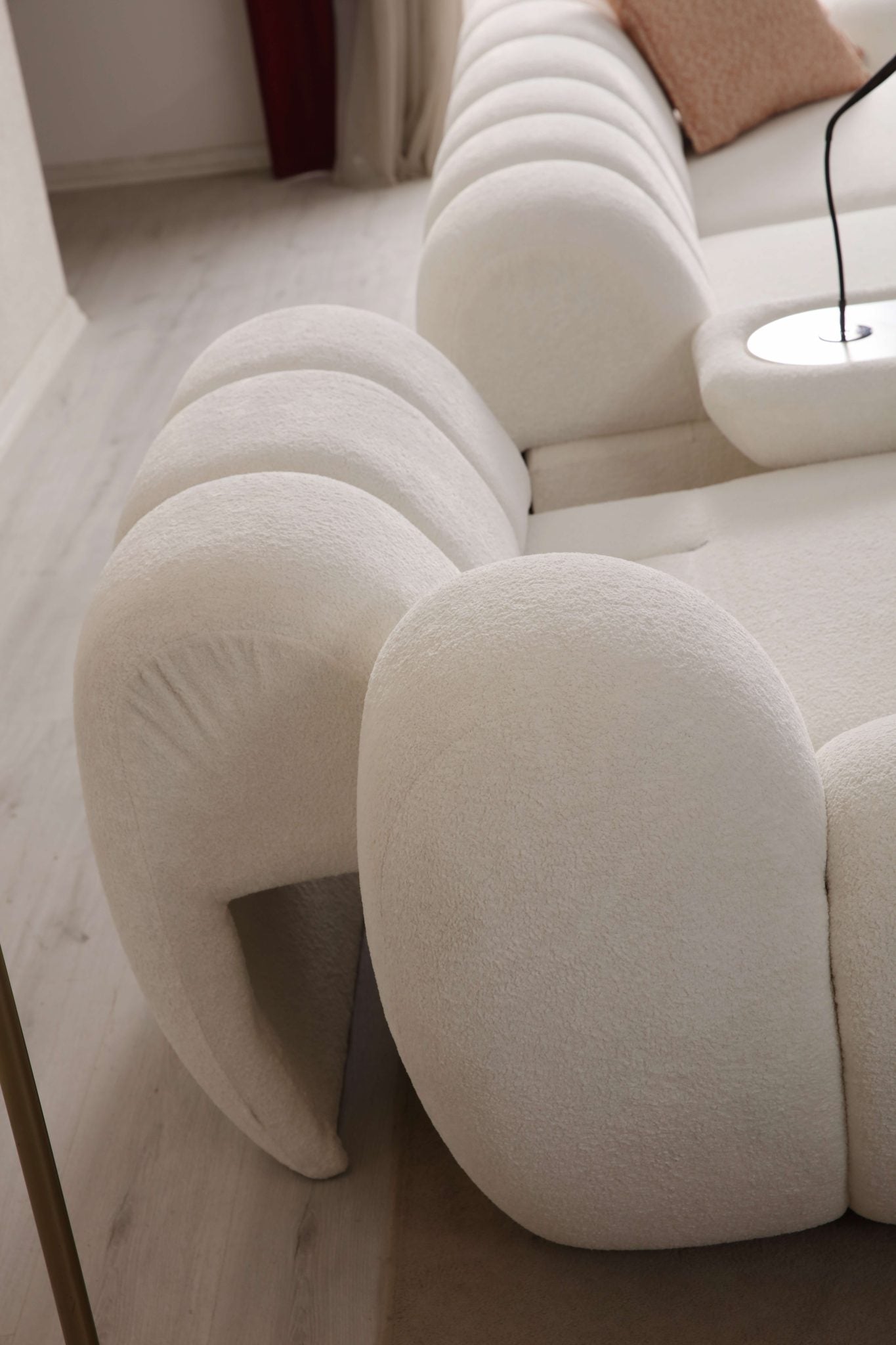 Lunar sculptural living room collection featuring curved modular sofa, rounded lounge chair, and modern minimalist interior design.