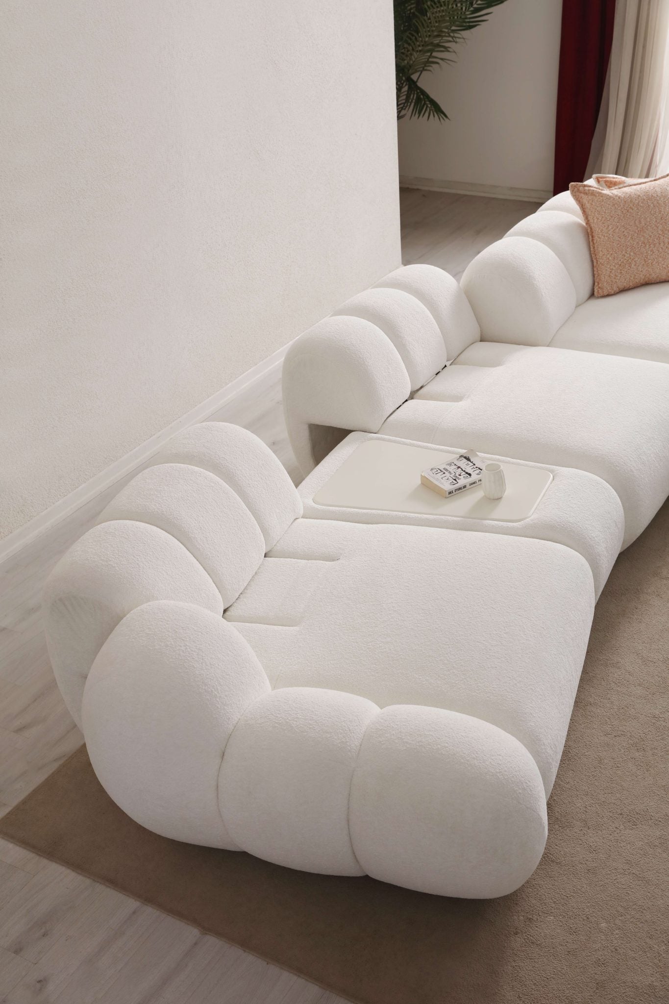 Lunar sculptural living room collection featuring curved modular sofa, rounded lounge chair, and modern minimalist interior design.