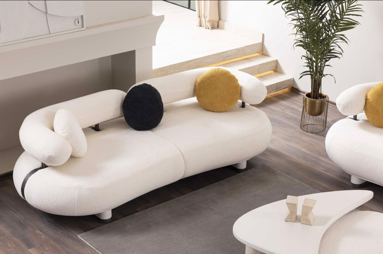 Amberhall modern curved furniture collection featuring sculptural sofa seating, ivory textures, and contemporary minimalist interior design.