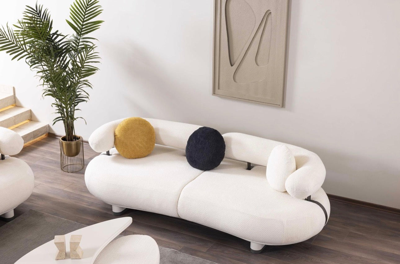 Amberhall modern curved furniture collection featuring sculptural sofa seating, ivory textures, and contemporary minimalist interior design.