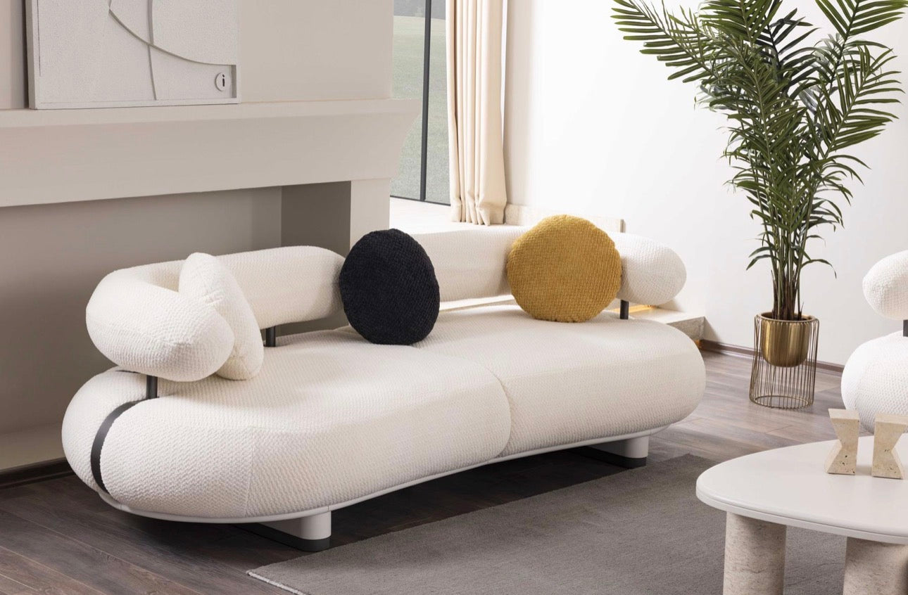 Amberhall modern curved furniture collection featuring sculptural sofa seating, ivory textures, and contemporary minimalist interior design.