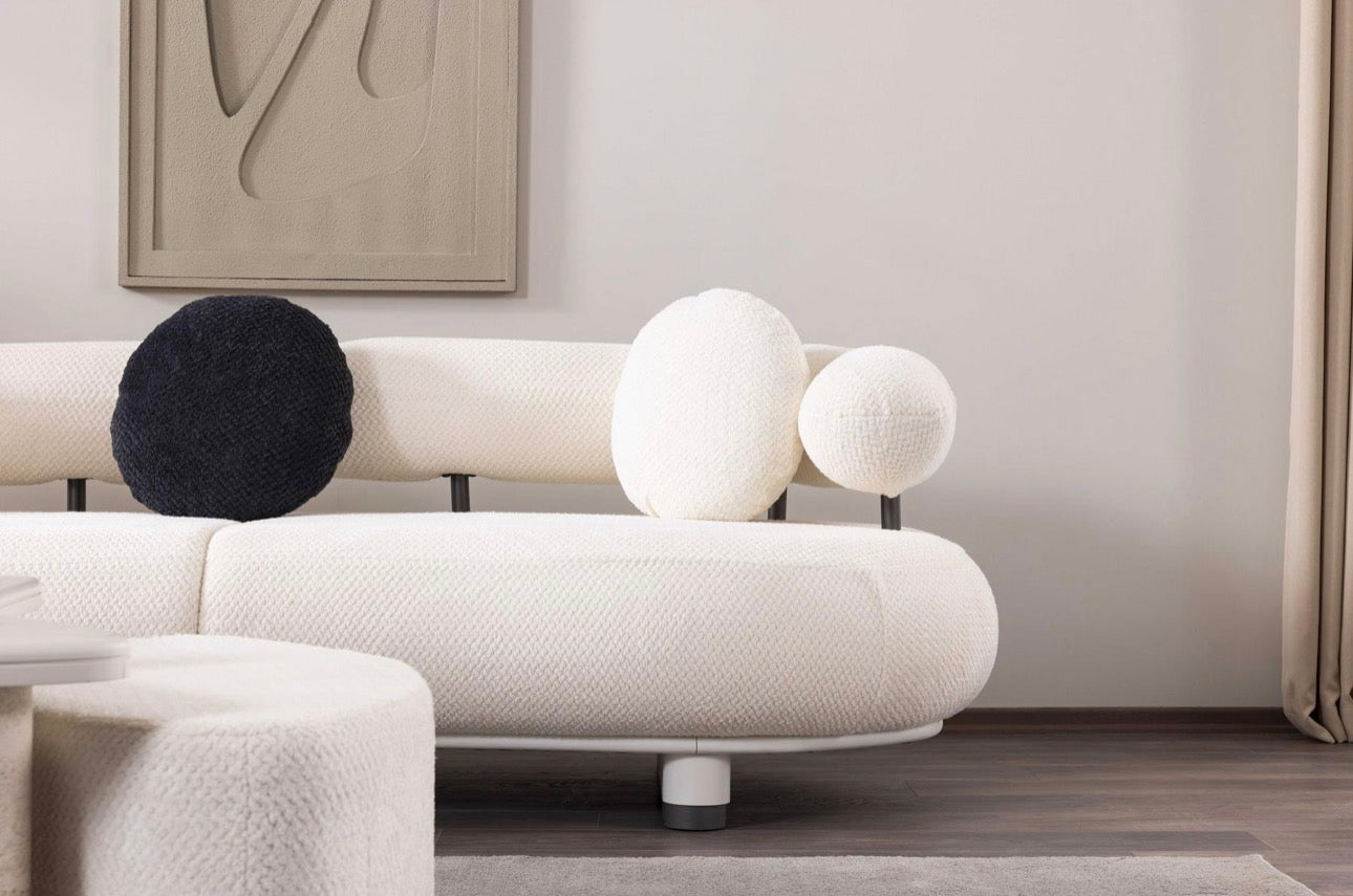 Amberhall modern curved furniture collection featuring sculptural sofa seating, ivory textures, and contemporary minimalist interior design.