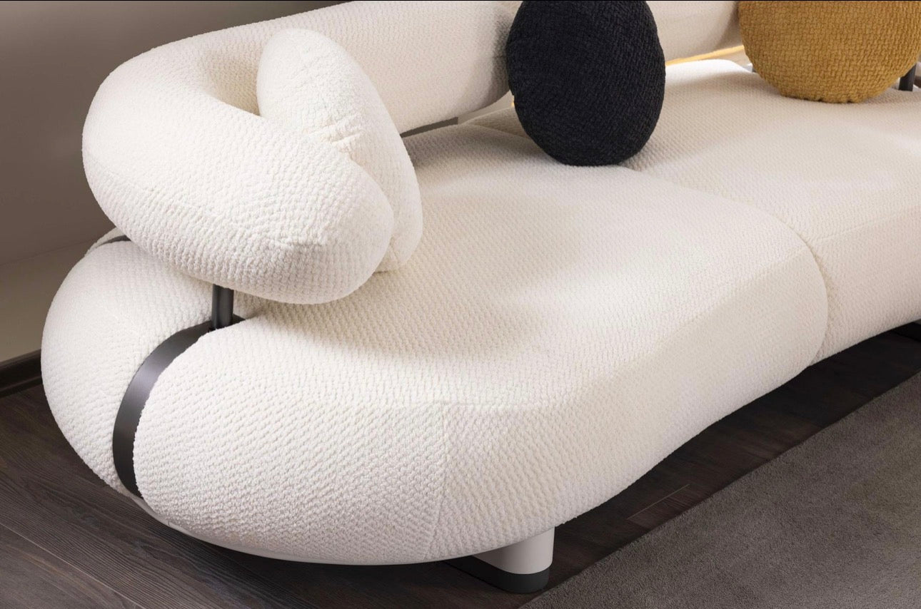 Amberhall modern curved furniture collection featuring sculptural sofa seating, ivory textures, and contemporary minimalist interior design.