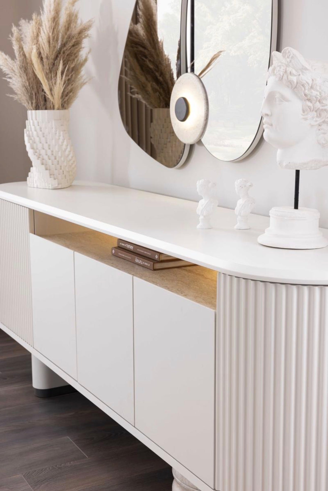 Amberhall modern curved furniture collection featuring sculptural sofa seating, ivory textures, and contemporary minimalist interior design.