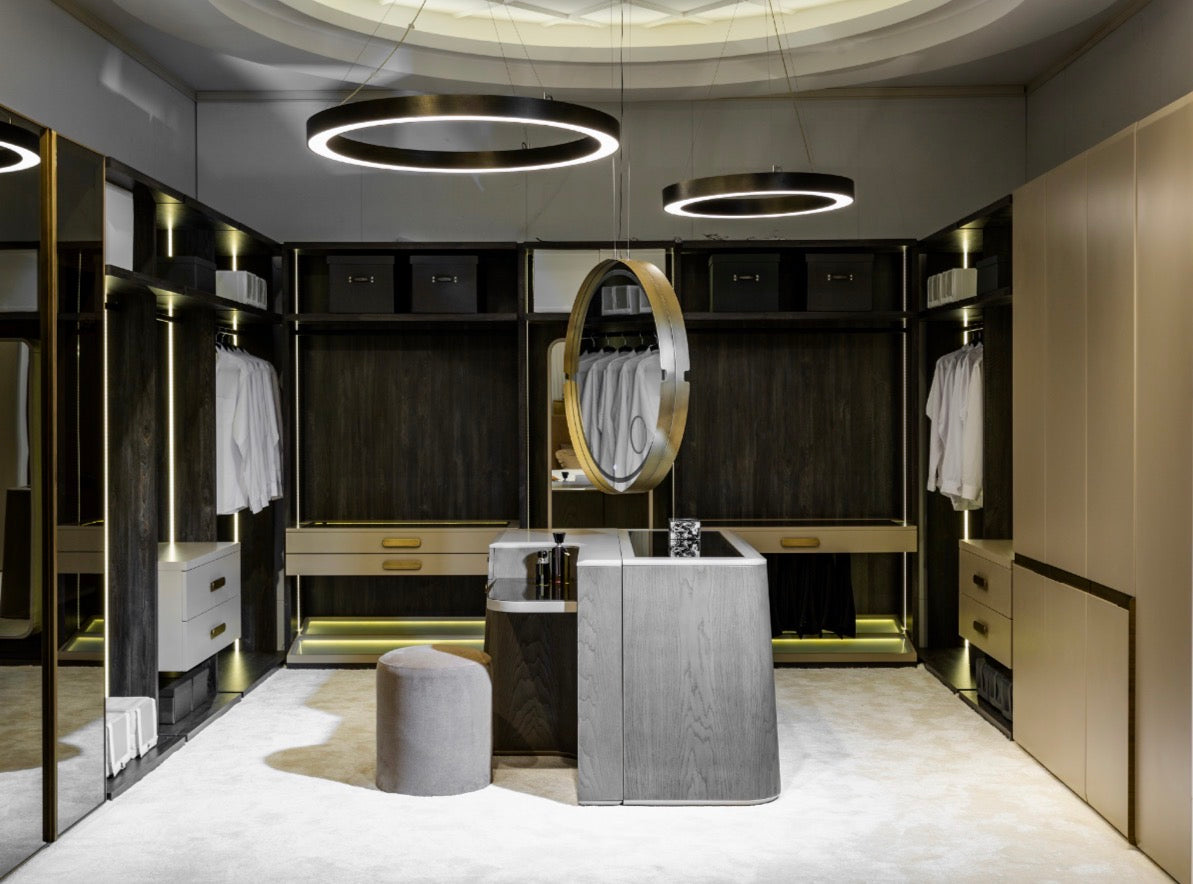 Stoneveil luxury furniture collection featuring modular sofa seating, modern dining table, sculptural accent chairs, luxury bedroom design, and illuminated walk in wardrobe.