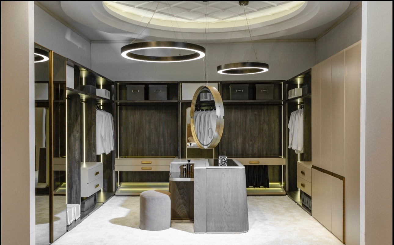 Stoneveil luxury furniture collection featuring modular sofa seating, modern dining table, sculptural accent chairs, luxury bedroom design, and illuminated walk in wardrobe.