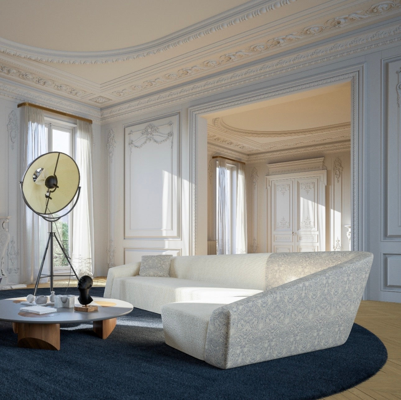 Overtime luxury furniture collection featuring curved sofa, sculptural lounge chairs, modern coffee table, and classic architectural interior setting.