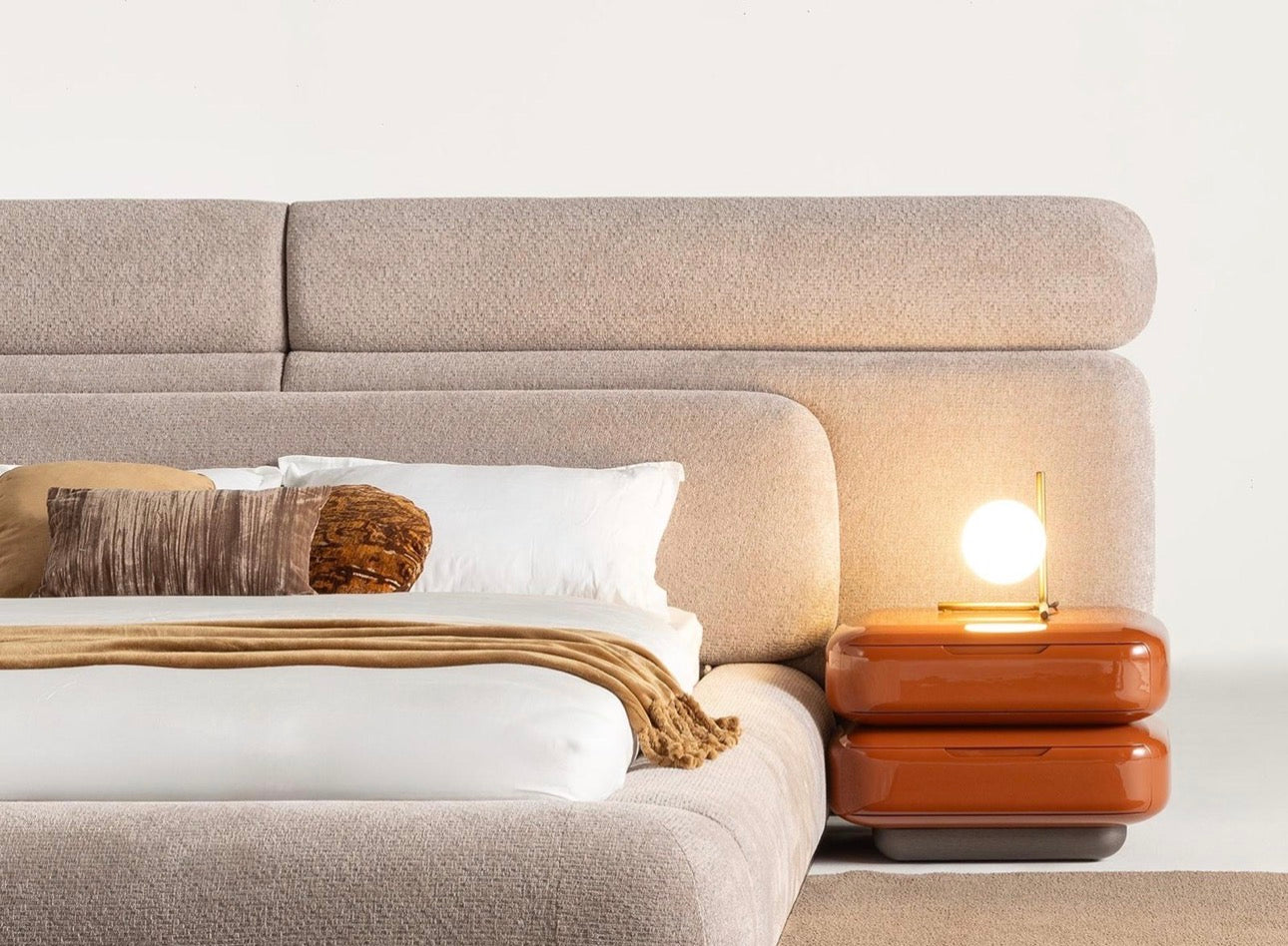 Urbane modern luxury furniture collection featuring sculptural dining table, curved bedroom furniture, and terracotta lacquer accents.