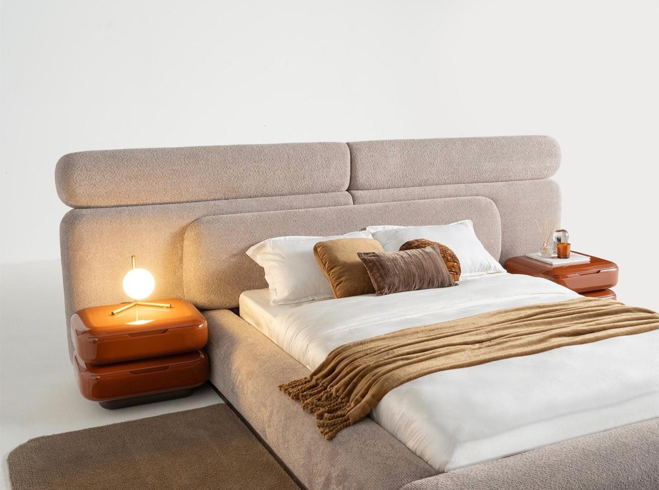 Urbane modern luxury furniture collection featuring sculptural dining table, curved bedroom furniture, and terracotta lacquer accents.