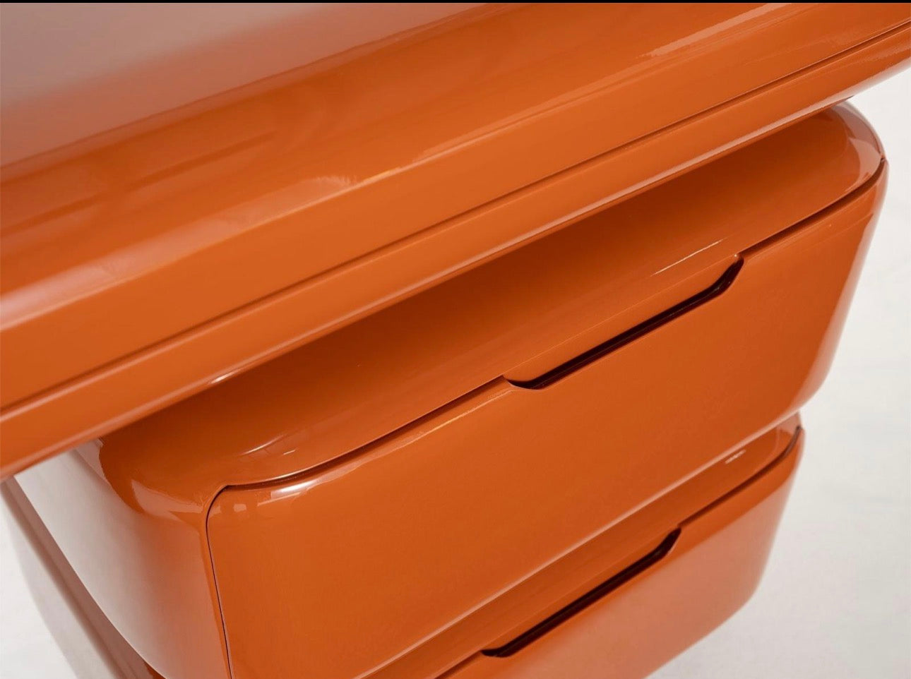 Urbane modern luxury furniture collection featuring sculptural dining table, curved bedroom furniture, and terracotta lacquer accents.